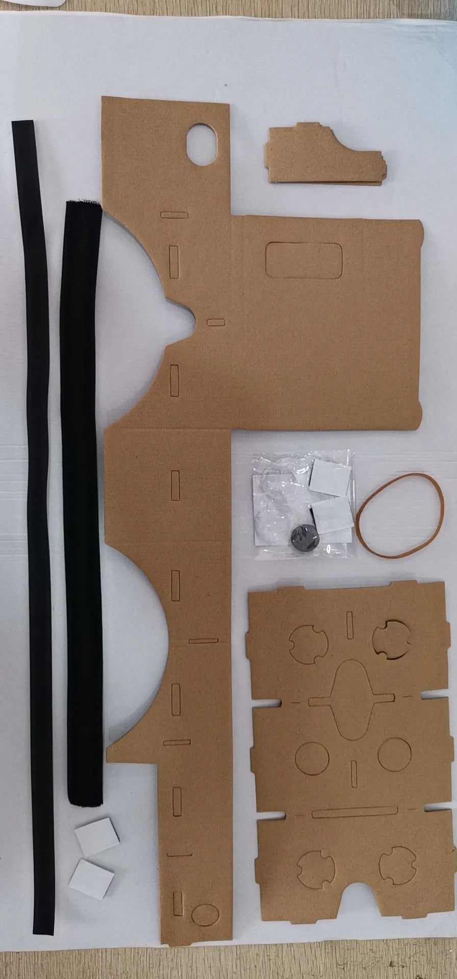 Pink and white foldable VR Cardboard viewer headset for 6-inch smartphones with head strap.