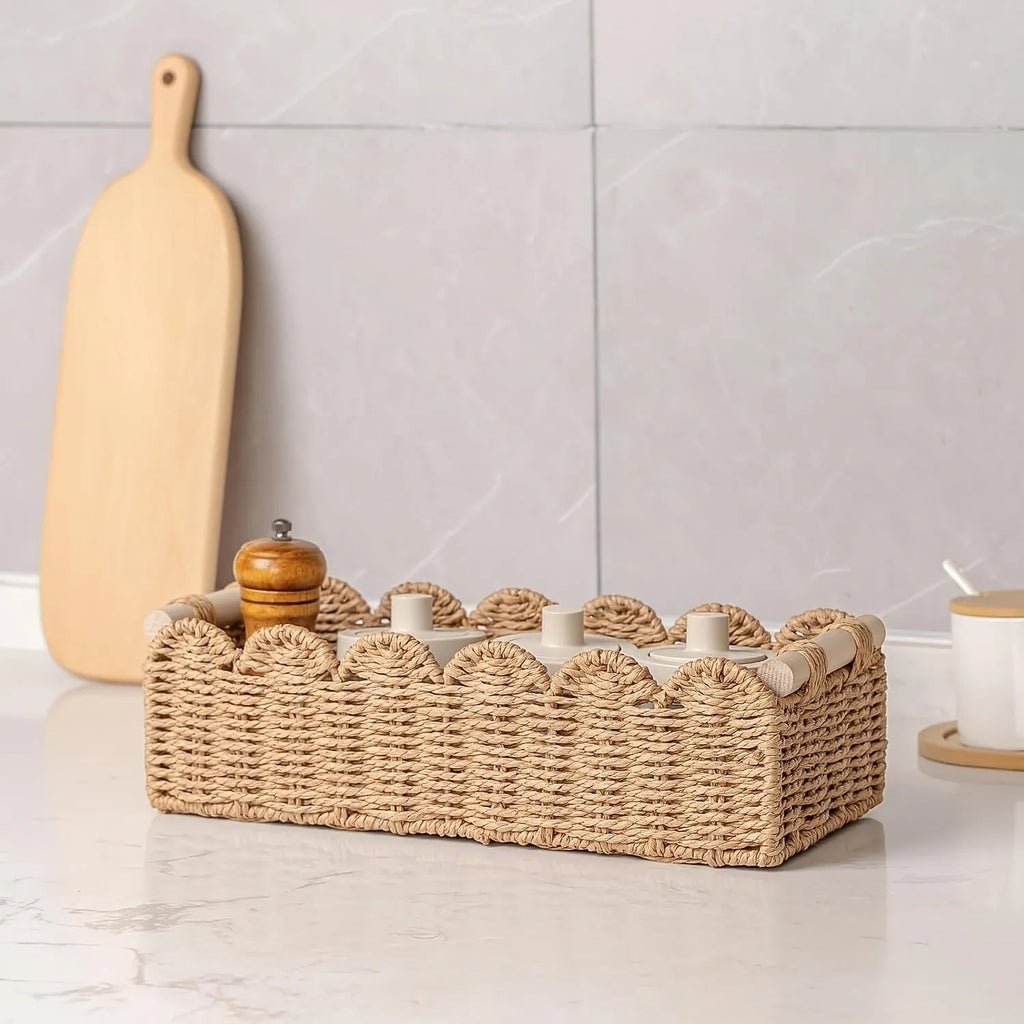 Modern weaved paper storage basket in khaki holding remote controls and stationery on a desktop