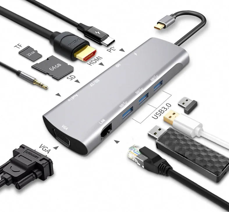 Grey aluminium USB-C docking station showing HDMI, VGA, USB 3.0, and USB-C PD ports with a short attached cable.