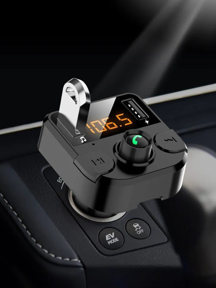 Black BT36B car Bluetooth MP3 player with 1.1-inch screen, plugged into a vehicle cigarette lighter socket.