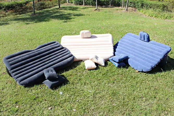 Black inflatable car bed with flocked surface, two pillows, and storage bag for five-seater vehicles