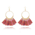 Big round drop dangle earrings in hand-woven geometric alloy design on white background