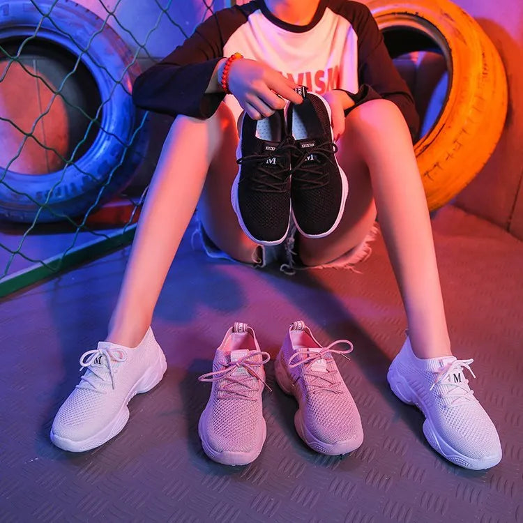 Women's white thick-soled casual sports shoes with woven upper and front strap closure.