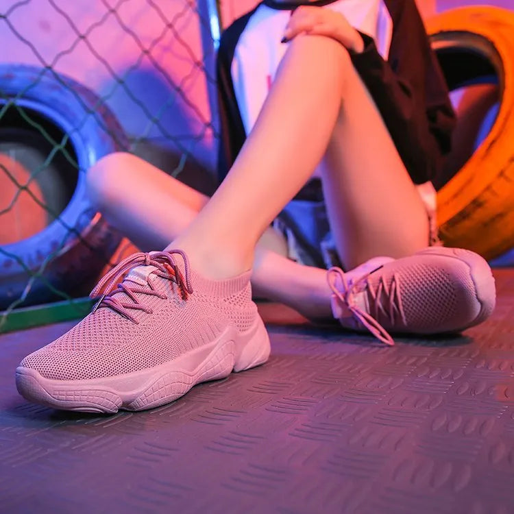 Women's white thick-soled casual sports shoes with woven upper and front strap closure.
