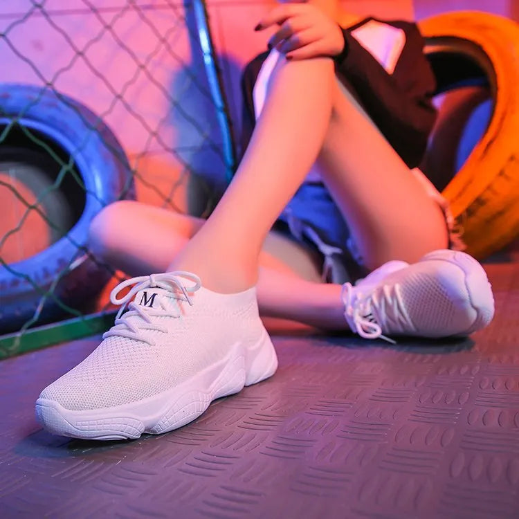 Women's white thick-soled casual sports shoes with woven upper and front strap closure.