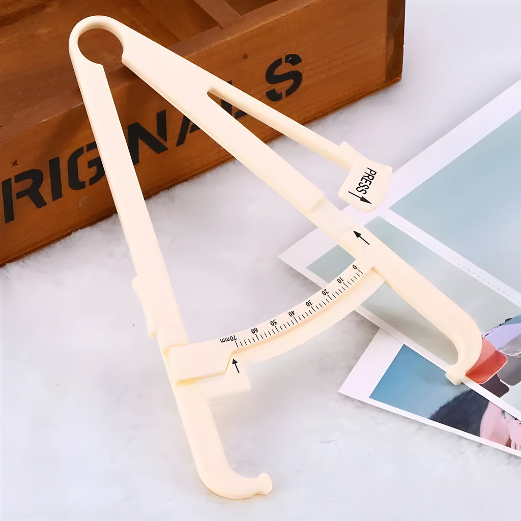 Acrylic body fat caliper measuring tool showing compact design and measurement scale