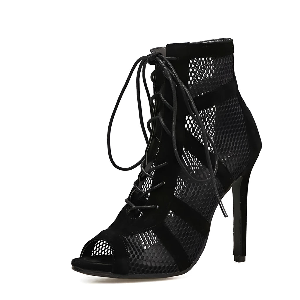 Black suede women's lace-up high heel shoes with a high heel on a plain background.