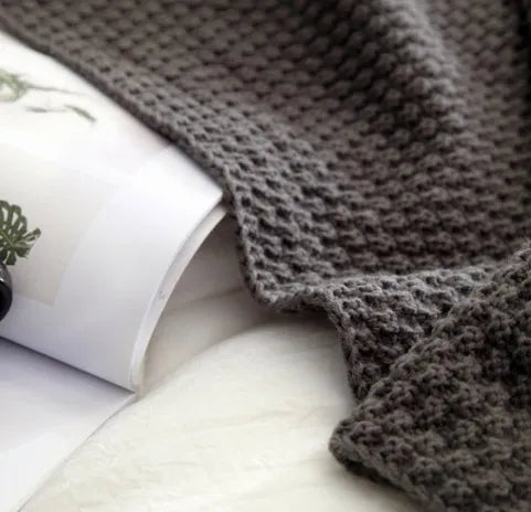 Nordic style fringed knit ball acrylic blanket in neutral colour on sofa