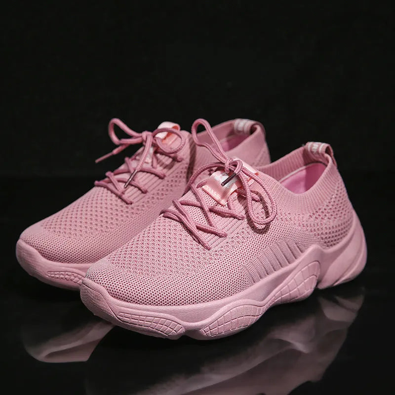 Women's white thick-soled casual sports shoes with woven upper and front strap closure.