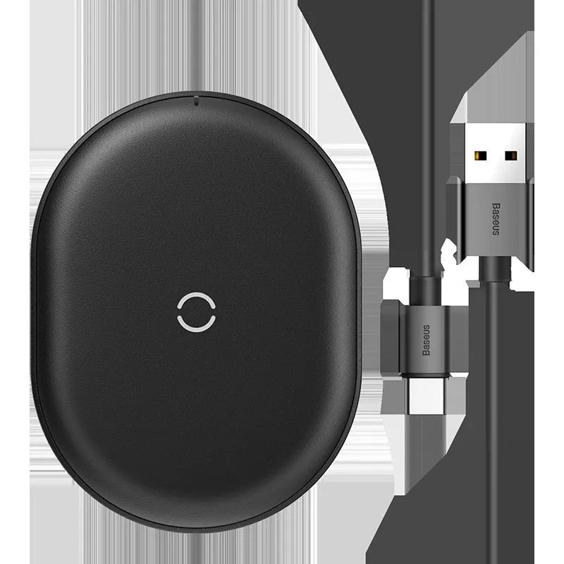 Baseus black wireless charging pad for mobile phones on a wooden surface