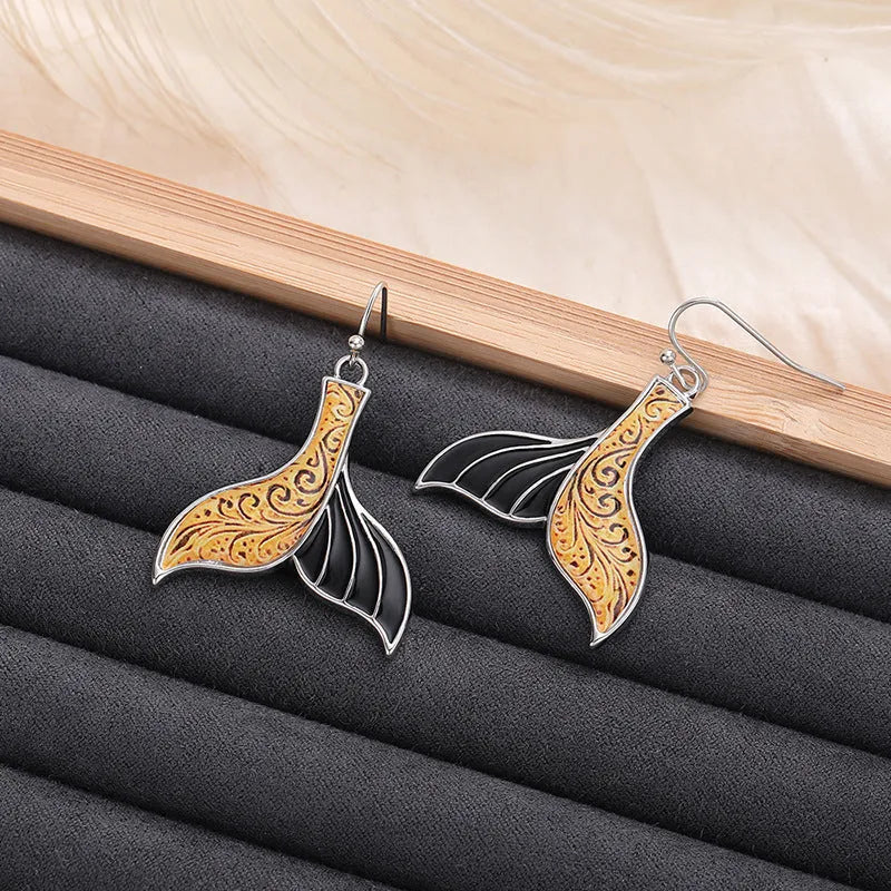 Women's white gold colour fishtail earrings with whale charm detail on alloy