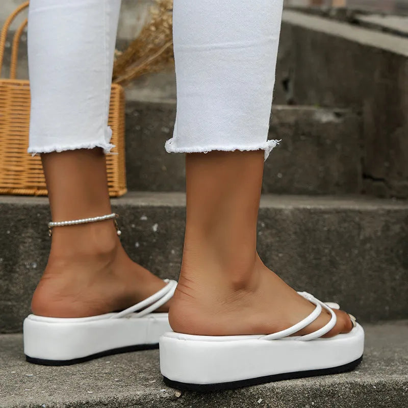 A pair of thick-soled herringbone pattern flip-flops in a chosen colour, showing the round toe and rubber bottom.