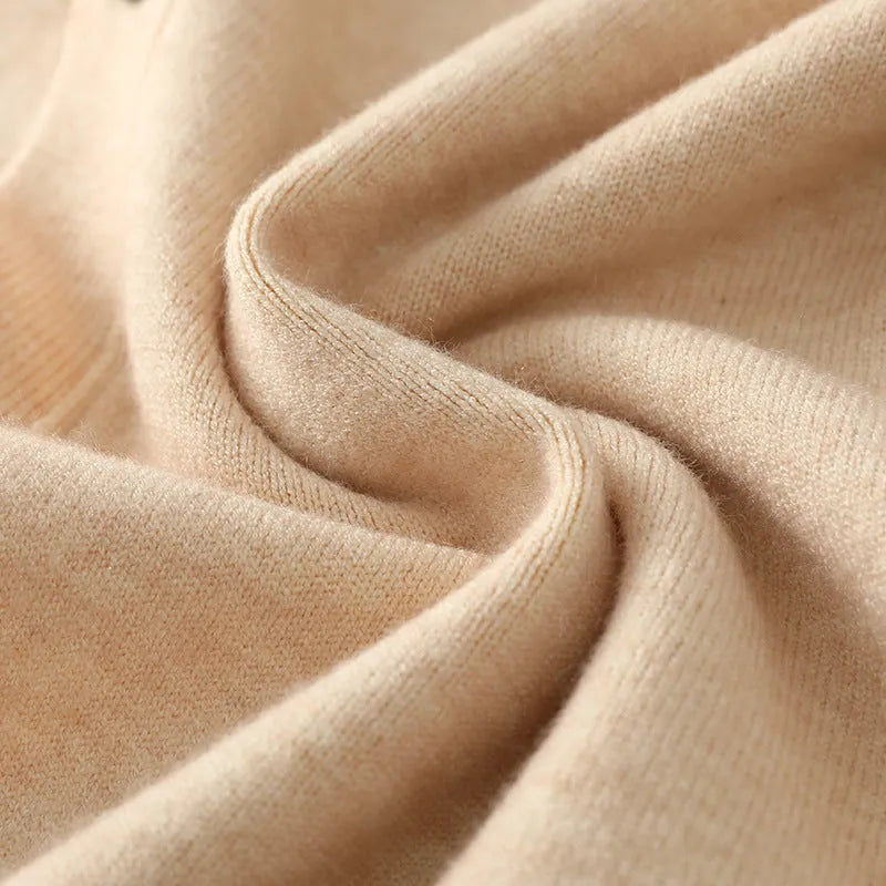 Man wearing a beige Andy velvet V-neck cardigan coat with long sleeves in a loose fit.
