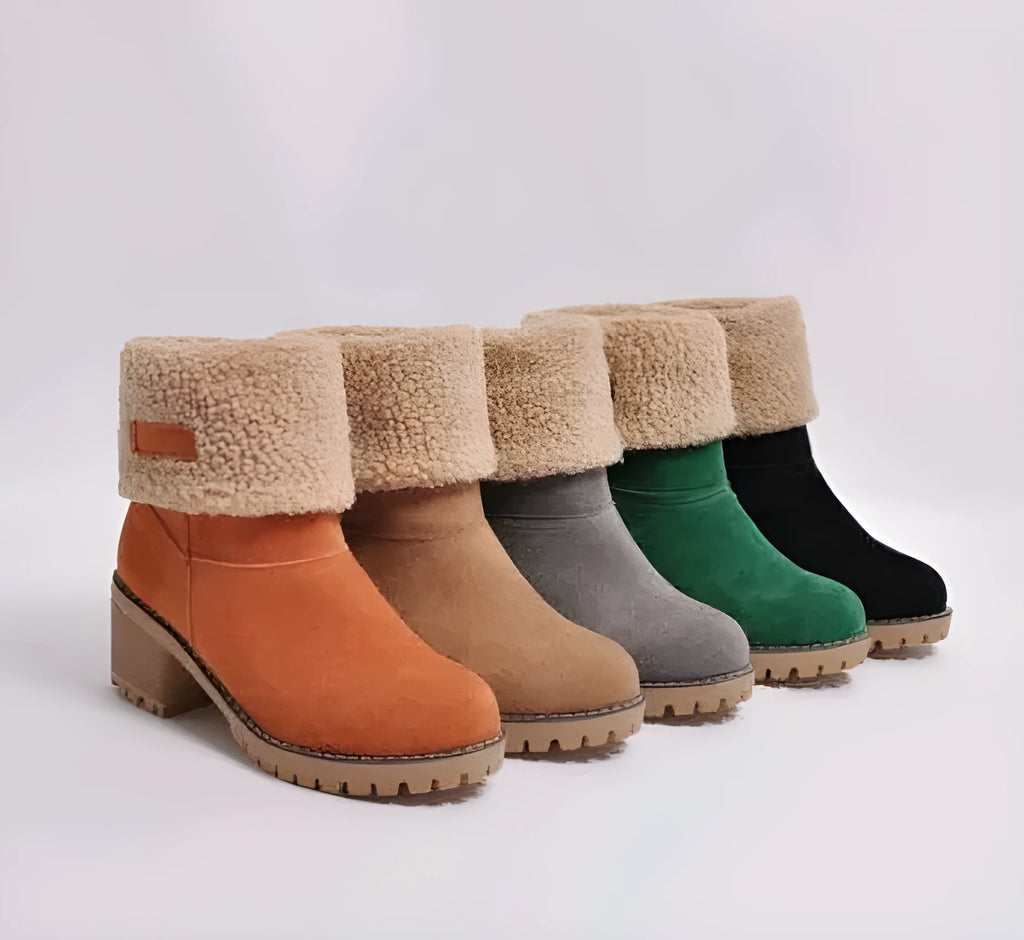 Women's black suede mid-tube snow boots with a round toe and thick low heel on a waterproof platform.