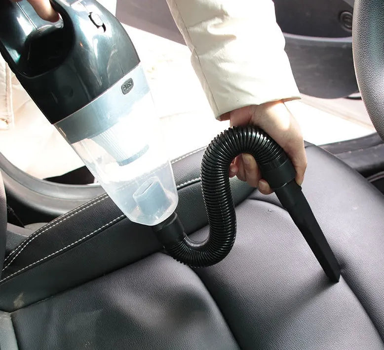 Orange, black, and blue coloured 12V portable handheld car vacuum cleaner with nozzles.