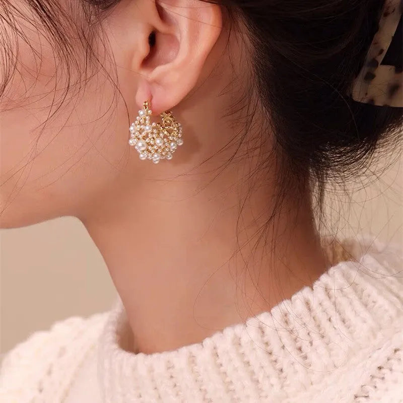 Gold-coloured copper flower basket earrings for women with small bead detailing and pearl inlay.