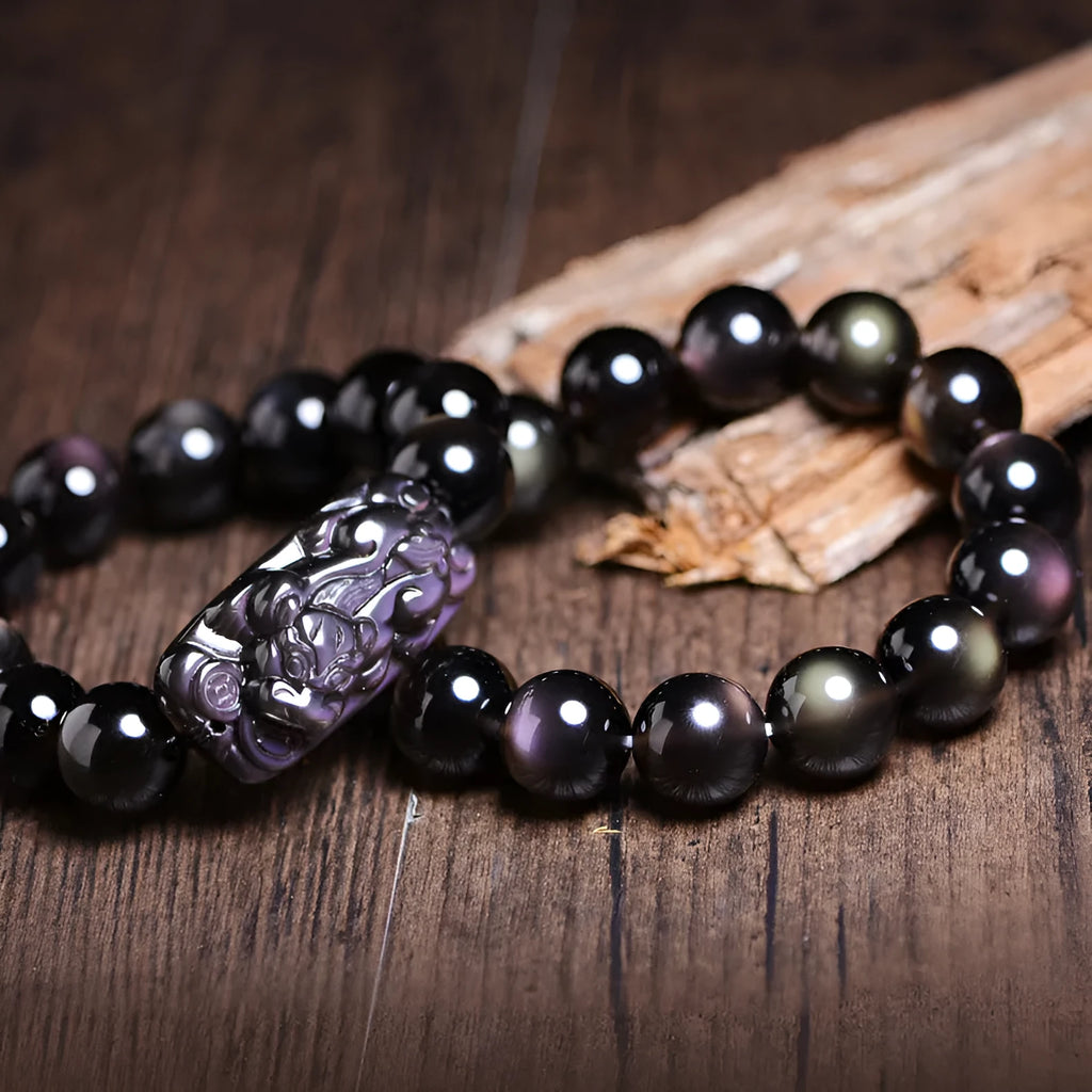 Polished crystal Pi Xiu bracelet with geometric beads in ice stone colour, showing size options on wrist.