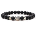 Natural stone stretch bracelet with round 8mm beads including tigereye and turquoise on a black background.