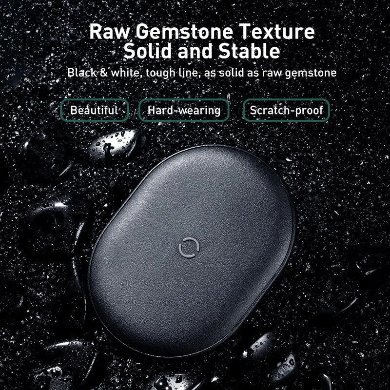 Baseus black wireless charging pad for mobile phones on a wooden surface