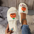 Halloween pumpkin plush slippers with open toe design in yellow colour showing synthetic fur and anti-slip soles