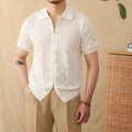 Men's light brown short sleeve cotton cardigan with zip front and lapel collar laid flat.