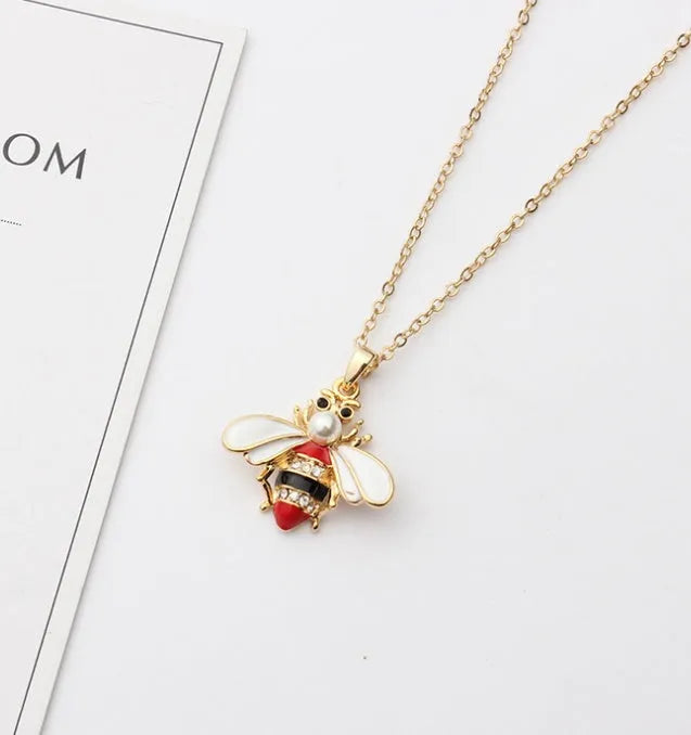 Cartoon bee drop pendant necklace on alloy cross chain for women, available in coffee, yellow, red colours