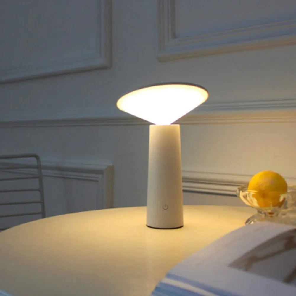 Black USB rechargeable table lamp with touch sensor and adjustable LED reading light head on a desk.