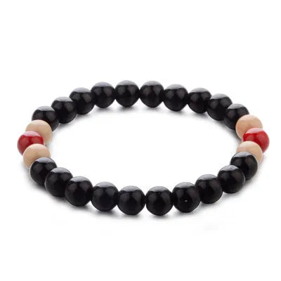 Unisex natural stone beaded bracelet with lava stones on a wrist, showing ethnic style design.