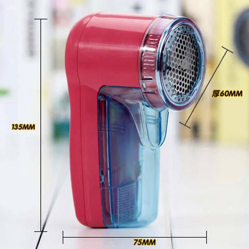 Compact blue portable electric lint remover for clothing on a grey sweater.