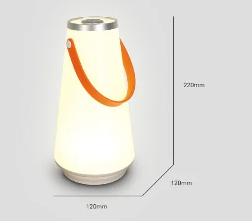 White rechargeable LED bedside table lamp with USB cable on a wooden surface.
