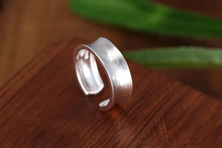 Geometric open ring with frosted sterling silver finish and adjustable opening design
