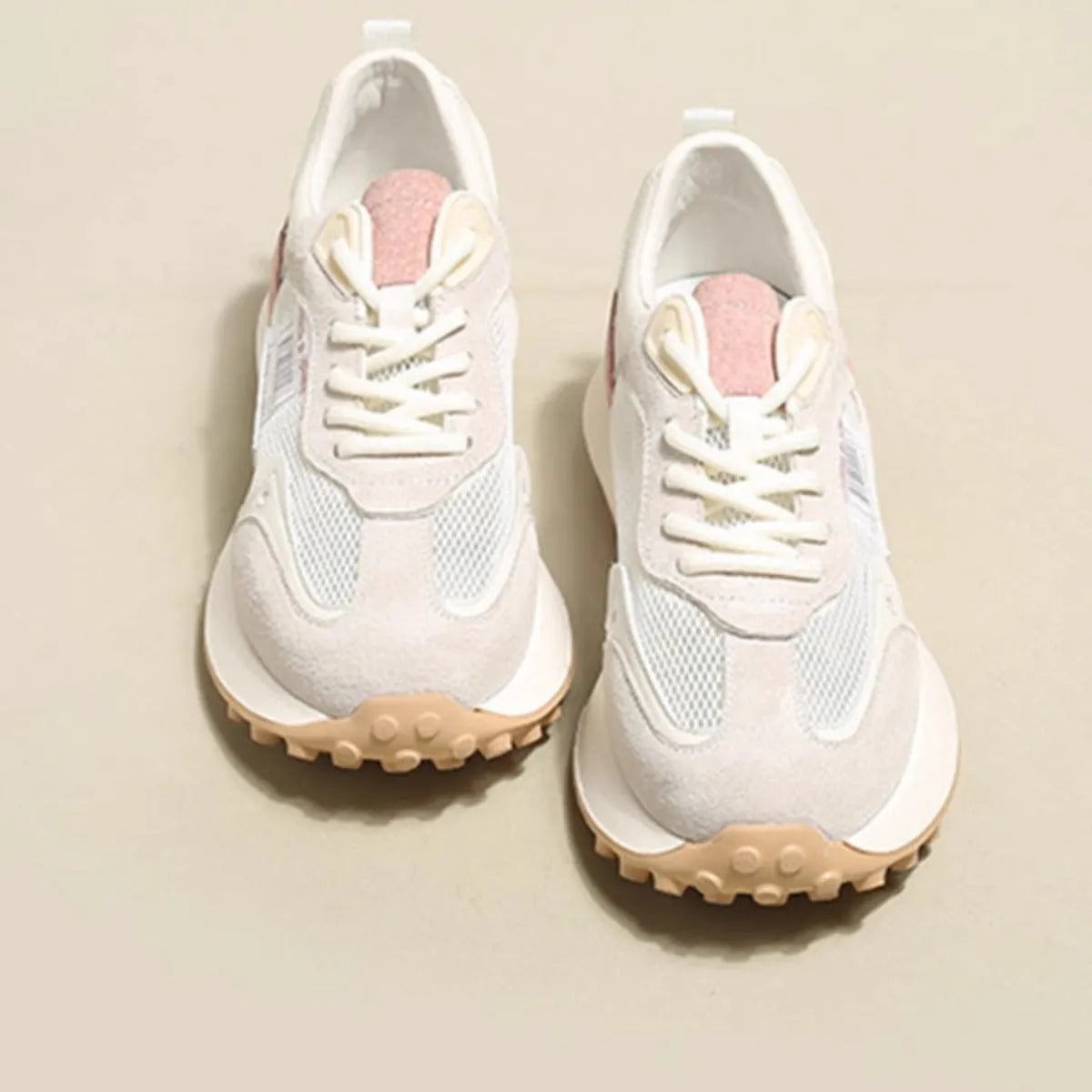 Women's pink and grey retro low-top sneaker with round toe and flat rubber sole.