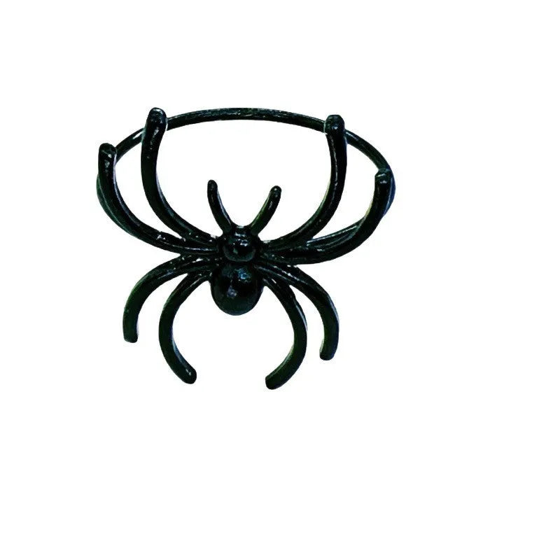 Six black alloy spider-shaped napkin rings for Halloween table settings.