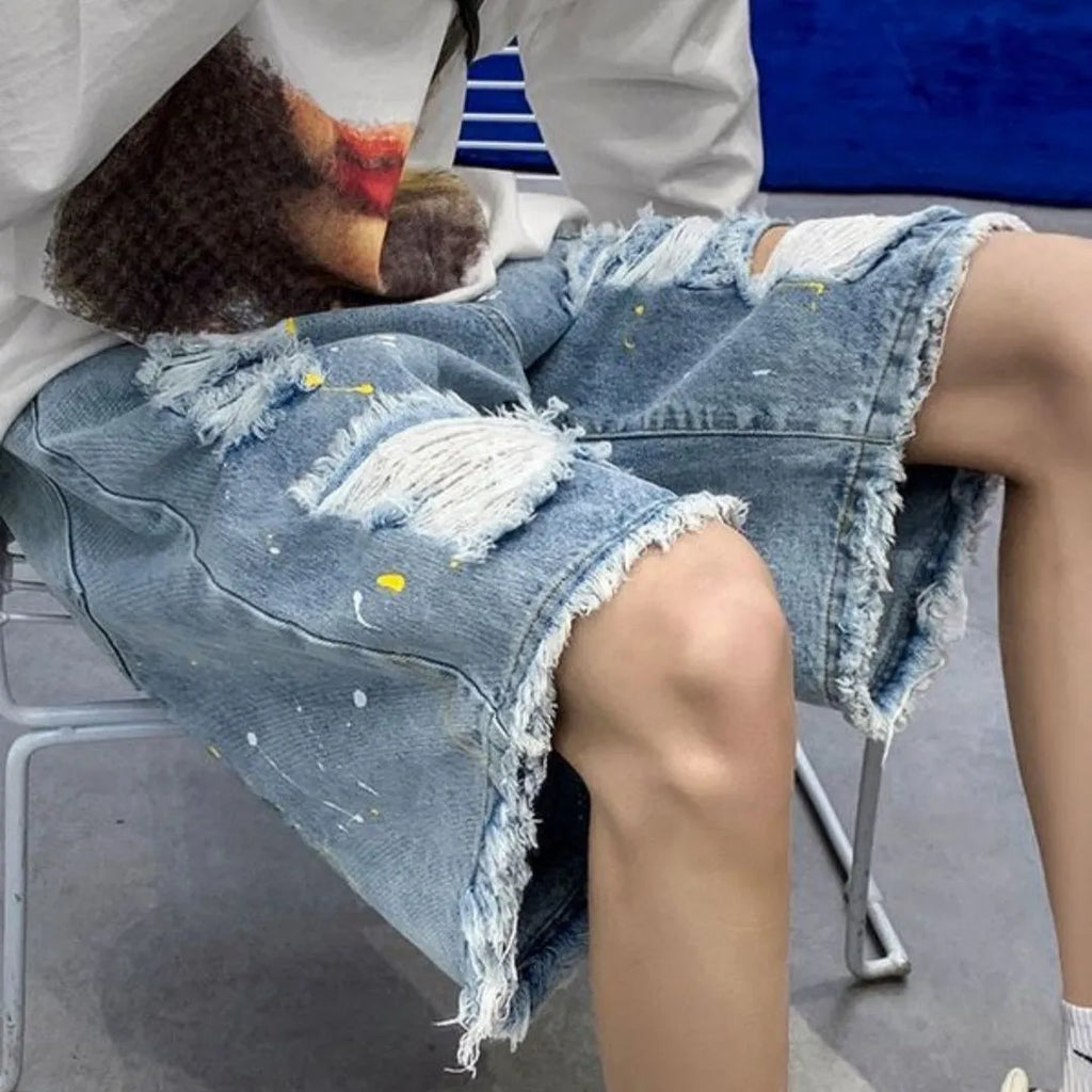 Men's loose fit water washed light blue denim shorts with hole details on a mannequin.