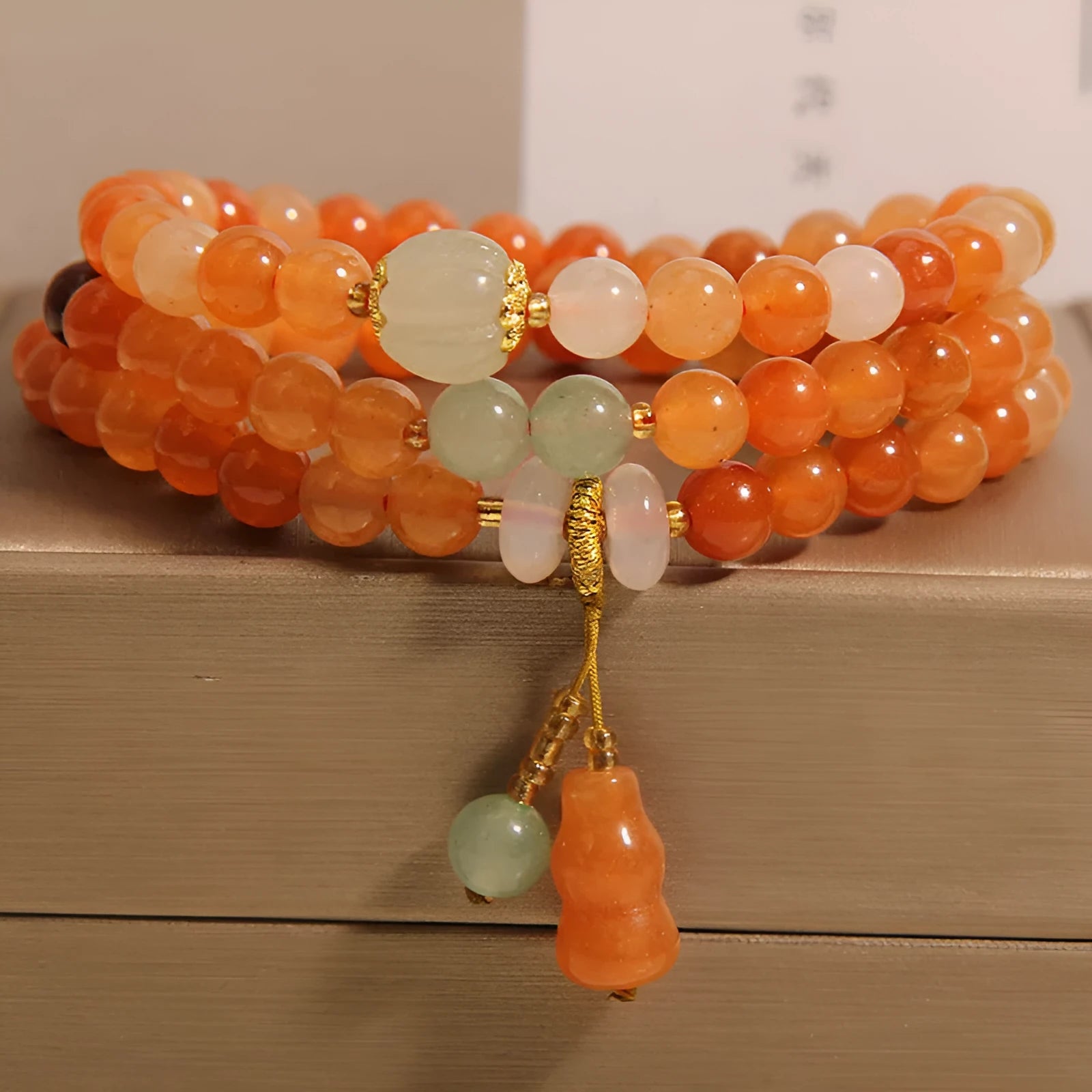 Artistic antique natural Jinsi Jade multi-layer bracelet with pumpkin beads and calabash pendant on white background