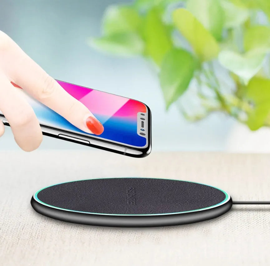 Black circular Qi wireless charging pad for iPhone 11 with LED indicator