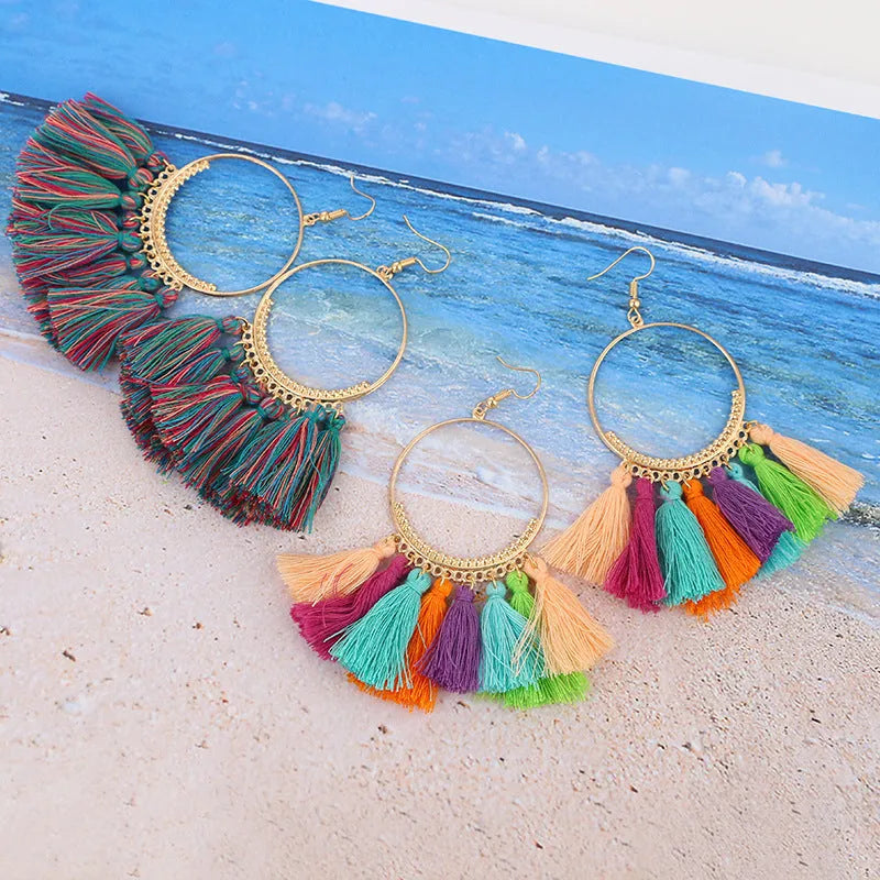 Big round drop dangle earrings in hand-woven geometric alloy design on white background