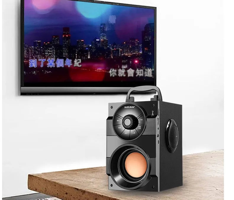Black portable mini home audio system with subwoofer, connection cable, and charging accessories
