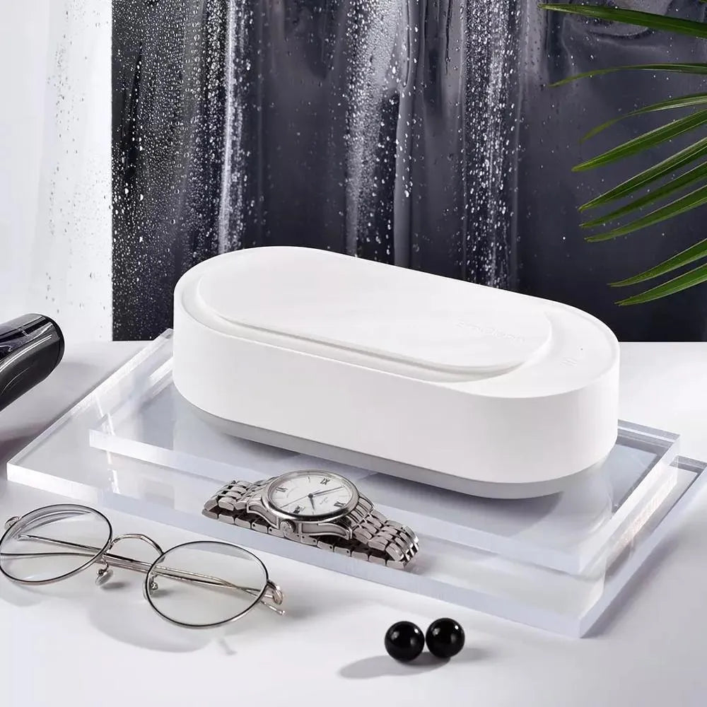 White portable ultrasonic cleaner with digital display and stainless steel cleaning tank.