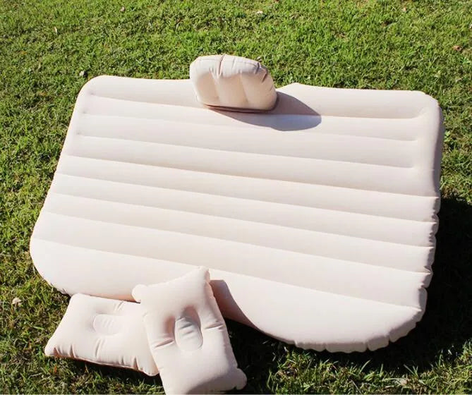 Black inflatable car bed with flocked surface, two pillows, and storage bag for five-seater vehicles