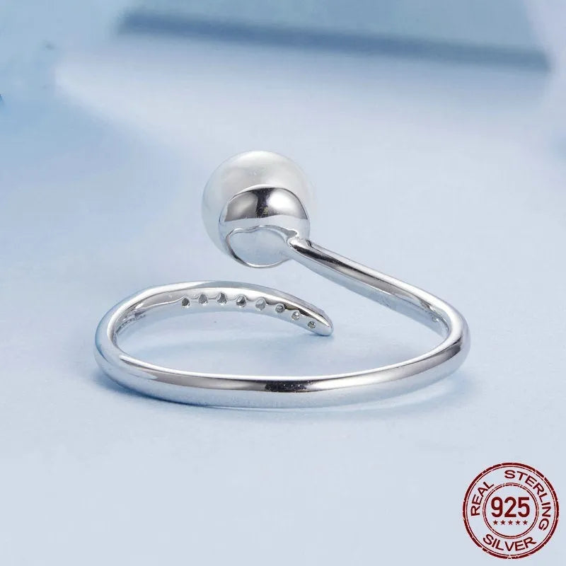 Adjustable sterling silver ring with natural shell pearls on open loop design