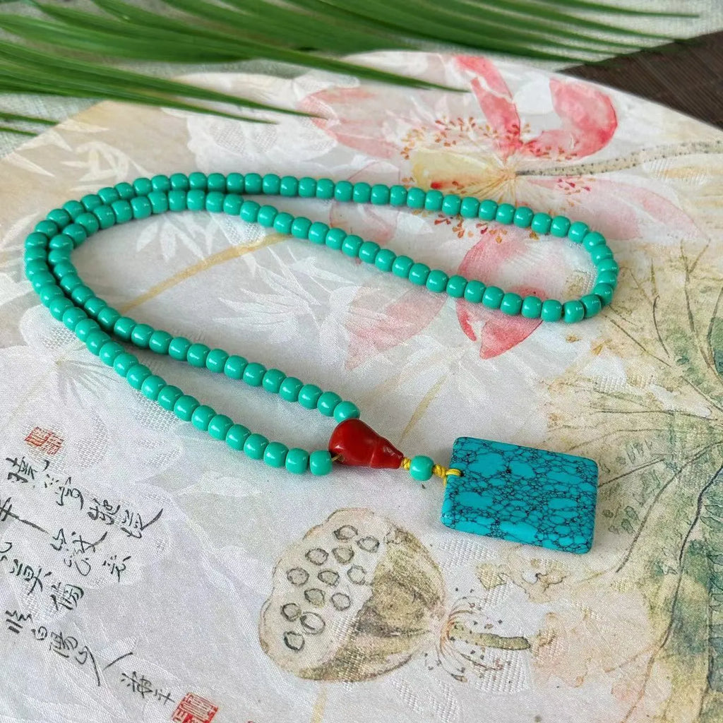Turquoise mesh flower lucky pendant on an adjustable ball bead necklace, 71-80cm long.