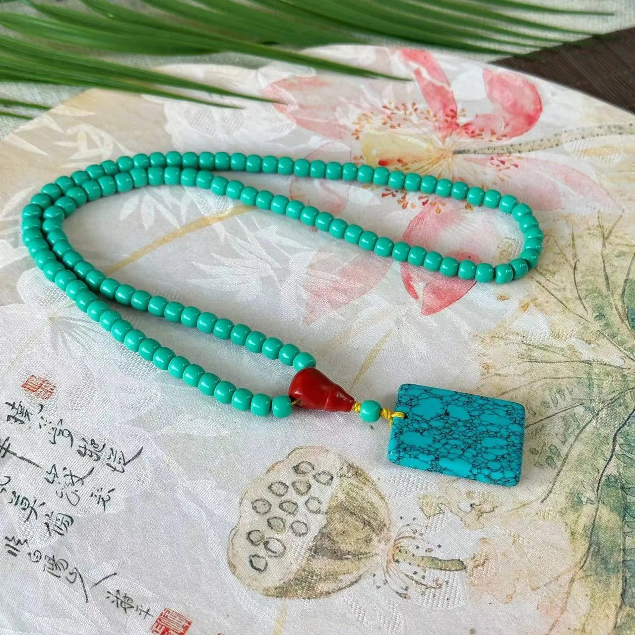 Turquoise mesh flower lucky pendant on an adjustable ball bead necklace, 71-80cm long.
