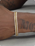 Gold tennis bracelet with titanium steel construction and artificial gemstone inlay on wrist