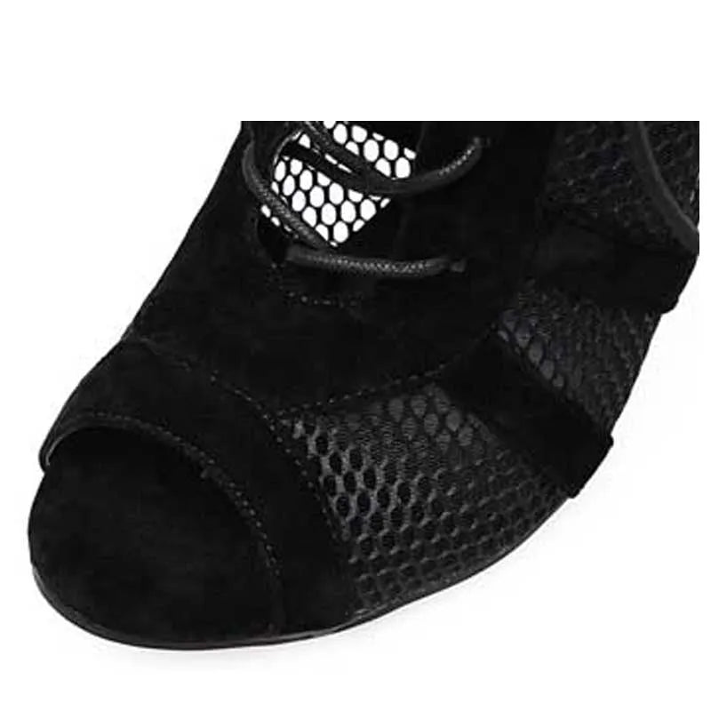 Black suede women's lace-up high heel shoes with a high heel on a plain background.