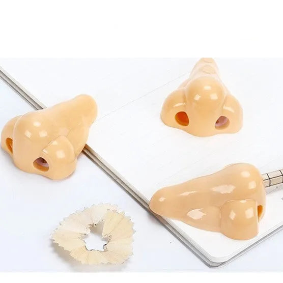 Flesh colour plastic pencil sharpener with large nostril opening for students