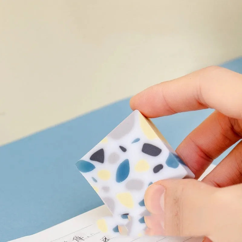White brick-shaped rubber eraser for traceless pencil mark removal on paper