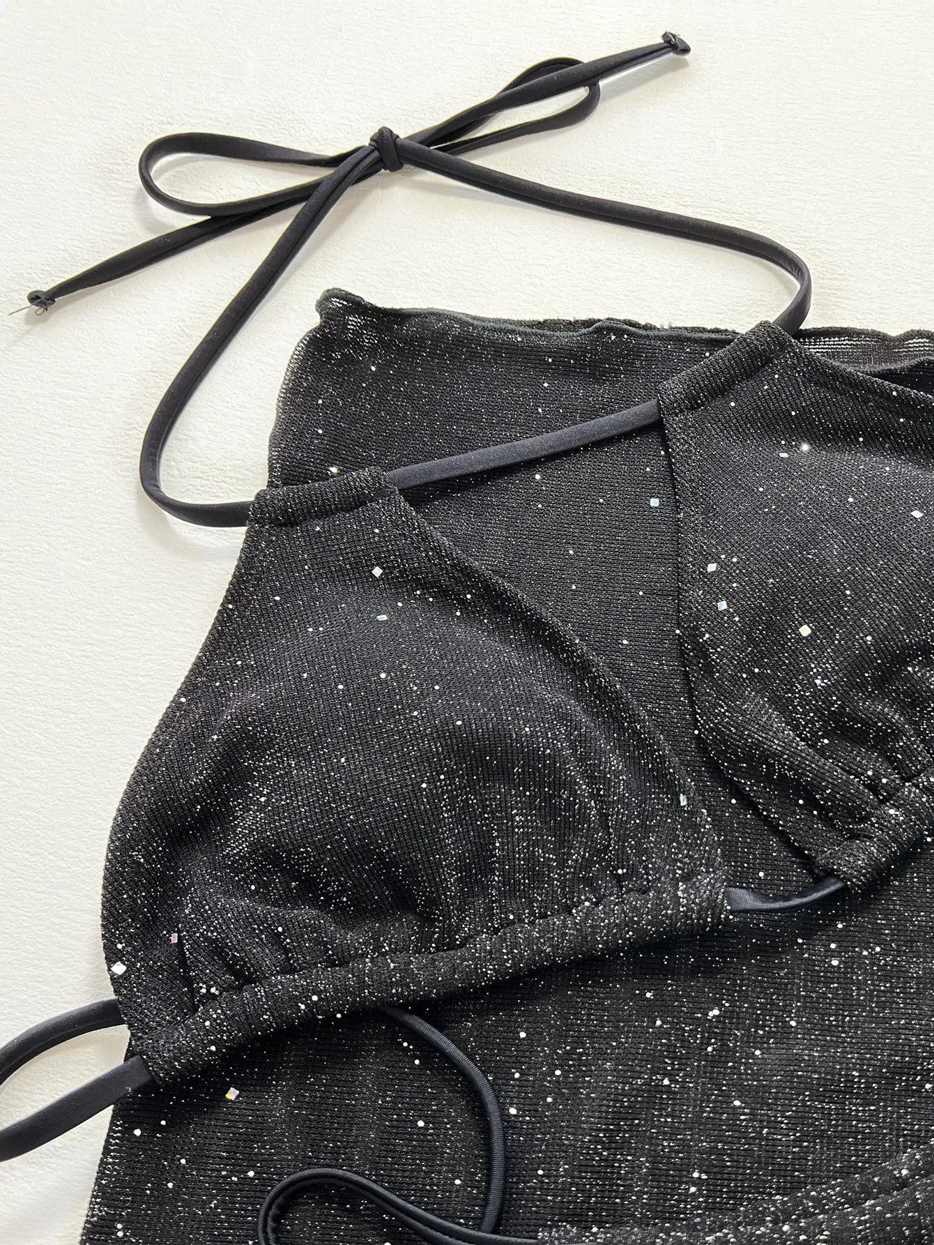 Black polyester three-piece bikini swimsuit set with separate top and shorts