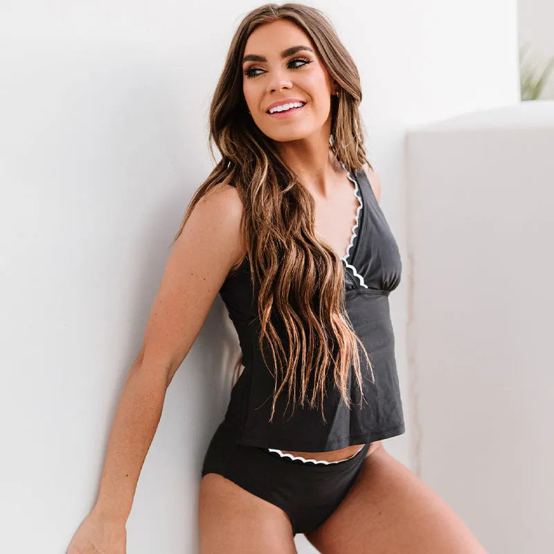 Black solid colour sleeveless one-piece women's swimsuit on a hanger