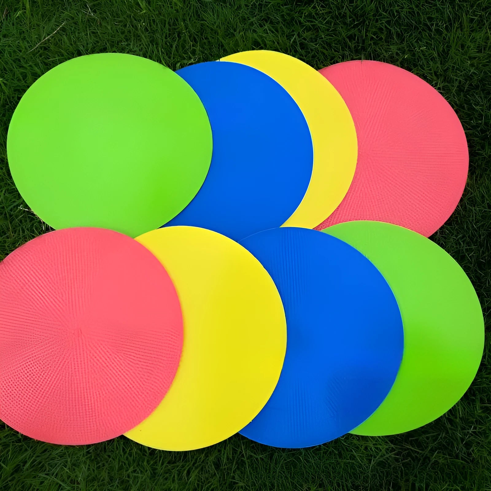 Yellow soft TPE football training target disc lying flat on grass